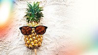 Cool pineapple with sunglasses on beach