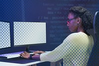 Female IT programmer working on blank screen computer
