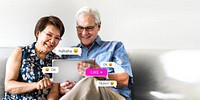 Senior couple using a digital device in a living room