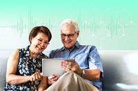 Senior couple using a digital device in a living room