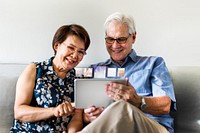 Senior couple using tablet remix