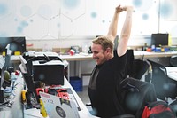 Man stretching arms during break time at office remix