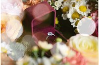 Closeup of Wedding Ring in Red Box with Flowers Arrangement Decoration