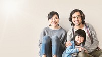 Happy Asian family sitting on floor