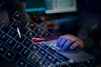 Man working on laptop in dark