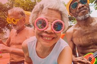 Closeup of diverse senior adults sitting by the pool enjoying summer together