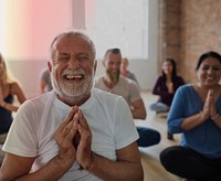 Smiling old man in yoga class