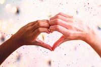 Heart shaped hands with decoration lights as a background