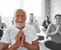 Smiling old man in yoga class