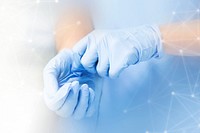 Nurse putting on blue gloves