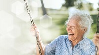 Cheerful senior woman on a swing at a playground
