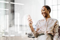 Happy black woman using phone