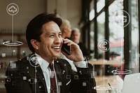 Happy businessman on the phone in a cafe