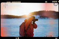 Photographer with a backpack enjoying the sunrise