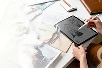 Fashion designer drawing on a digital tablet