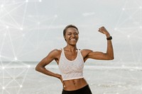 Cheerful black woman flexing her muscles by the seaside