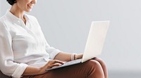 Cheerful woman working on laptop