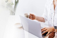 Businesswoman drinking coffee while working at home