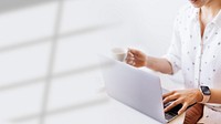 Businesswoman drinking coffee while working at home