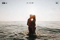 Romantic couple in the sea at sunset