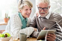 Happy senior couple using tablet