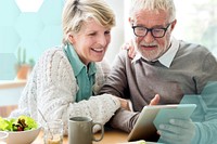 Happy senior couple using tablet