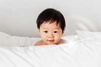 Closeup of a baby playing with a pillow