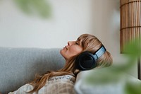Woman listening to music on sofa remix