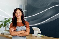 Smiling female small business owner at a cash register