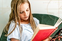 Young girl reading a book on a couch, new normal hobby