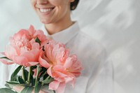 Happy woman holding a bouquet of peonies remix