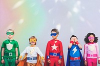 Diverse children in colorful superhero costumes