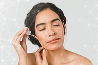 Young woman applying serum on her face
