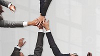 Businessmen stacking hands in middle