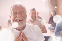 Smiling old man in yoga class