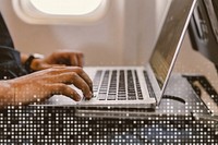 Man using a laptop on a plane