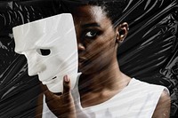 Thoughtful woman holding white mask