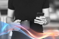 A man texting on his phone while holding a black coffee cup in the other hand