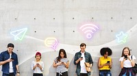 Group of young adults outdoors using smartphones together and chilling