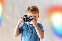 Caucasian boy playing with a camera