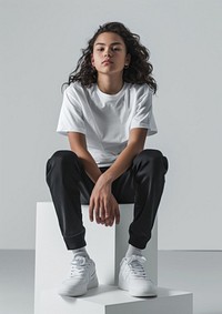 Teenage wearing white t shirt mockup clothing footwear sitting.