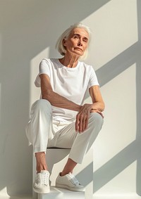 Senior woman wearing white t shirt mockup sitting person female.