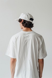An oversized white t-shirt and white cap beachwear clothing apparel.