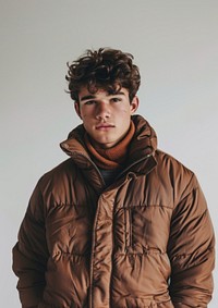 A man wearing a brown puffer vest photography clothing portrait.