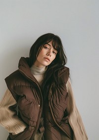 A woman wearing a brown puffer vest mockup photography fashion clothing.