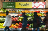 Grocery store sign over vegetable shelf
