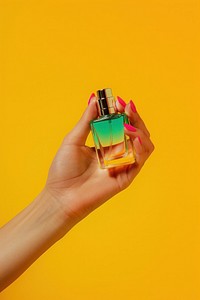 Woman hand hold a perfume bottle cosmetics nail polish.
