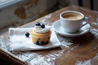 Blueberry cupcake on a white linen napkin beverage produce dessert.