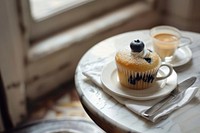 Blueberry cupcake on a white linen napkin windowsill dessert muffin.