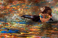 Boy swimming intently accessories photography recreation.
